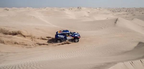 The blue SBVTools MINI racing through the dunes at the Abu Dhabi Desert Challenge 2022